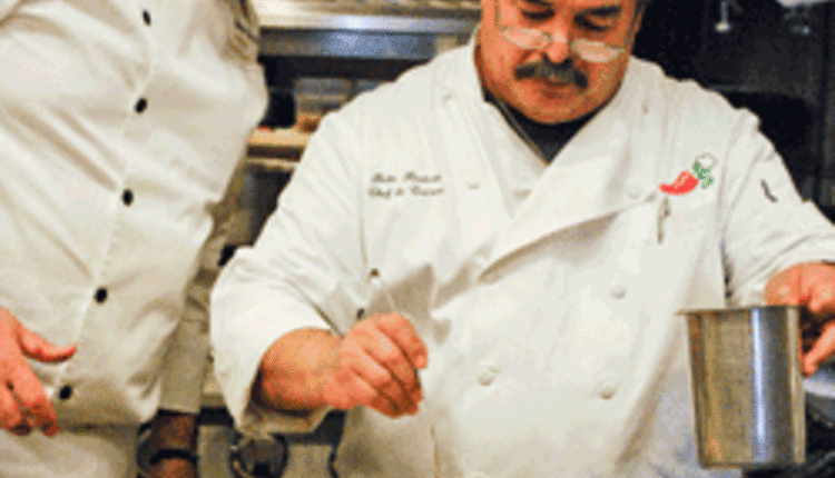 chefs cooking a meat dish