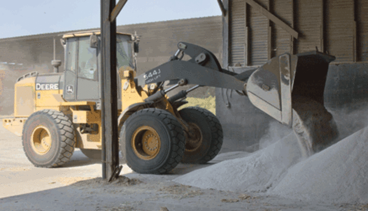 tractor loading minerals for a ration