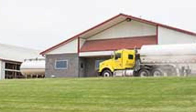 milk trcuk in fron tof dairy barn